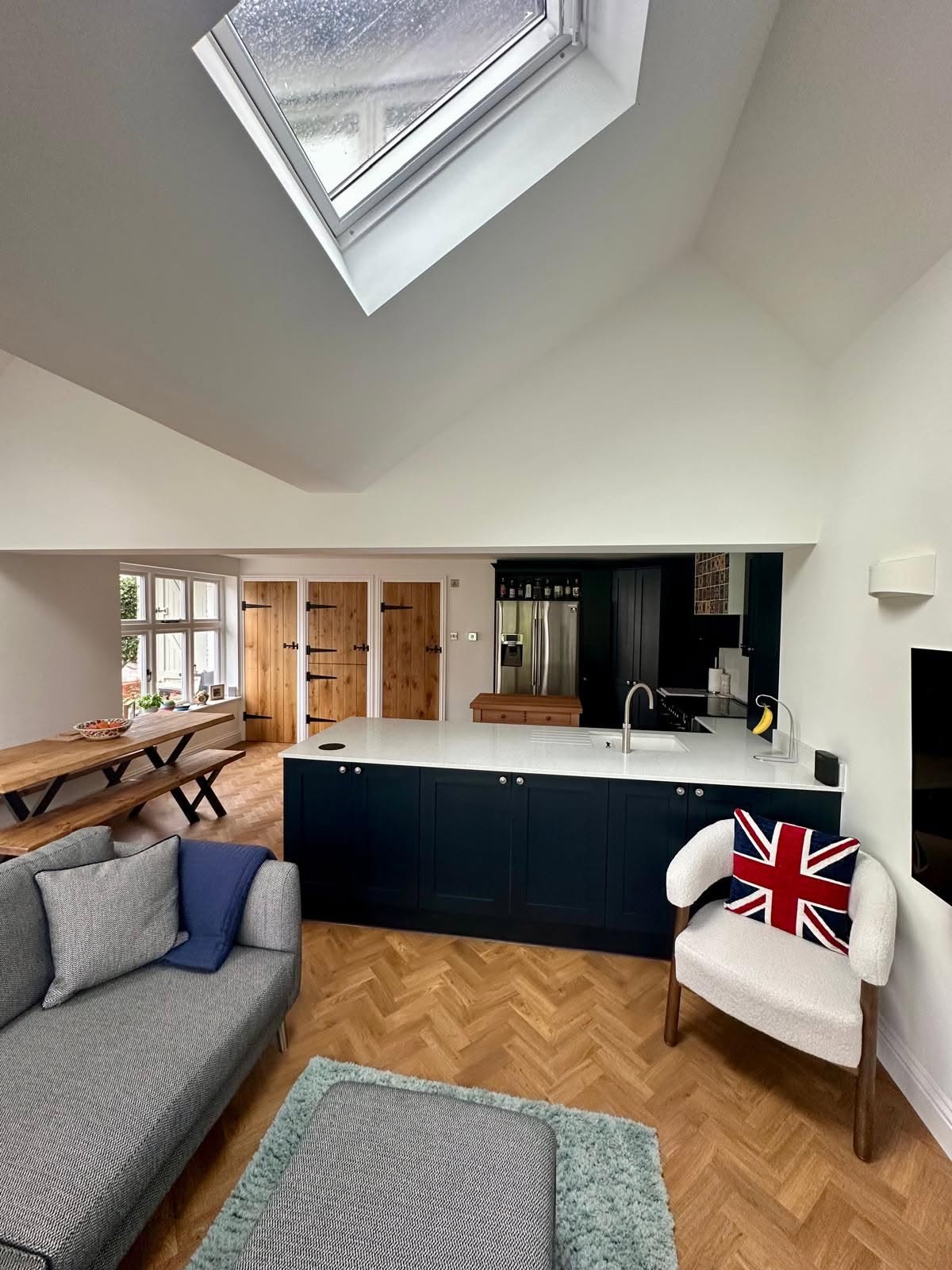 Kitchen and dining extension under a vaulted ceiling with a large rooflight