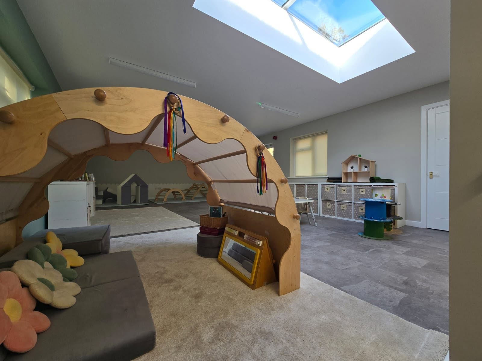 Refurbished classroom interior with a large skylight and bespoke timber activity arch