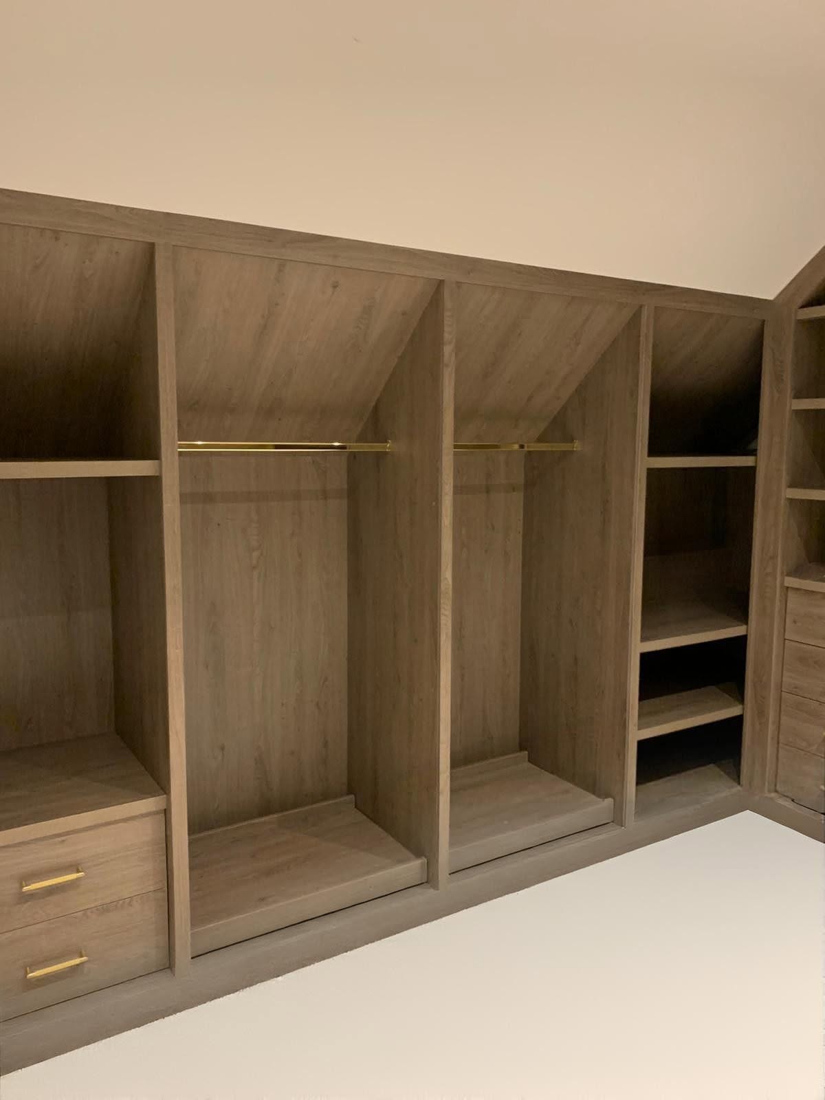 Loft conversion with bespoke oak-effect fitted wardrobes under sloping eaves