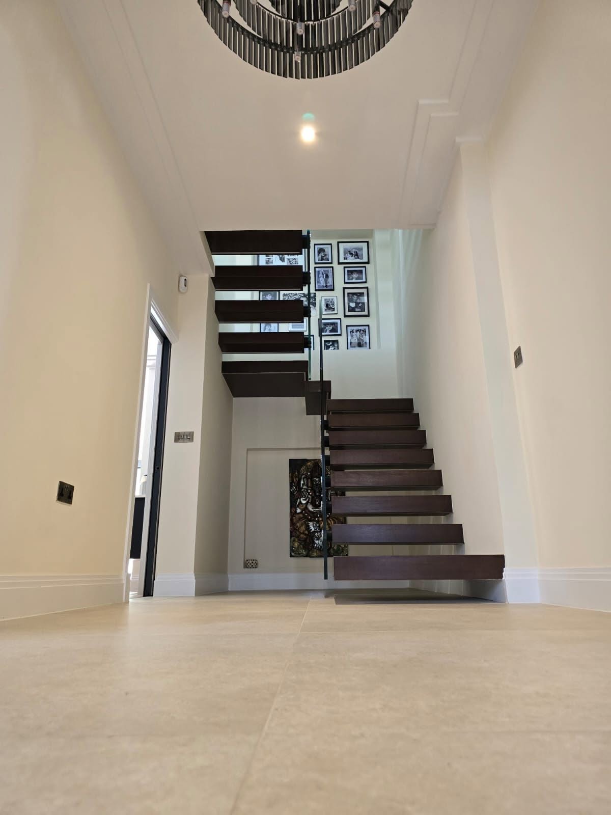 Construction project: dark timber floating staircase with frameless glass balustrade