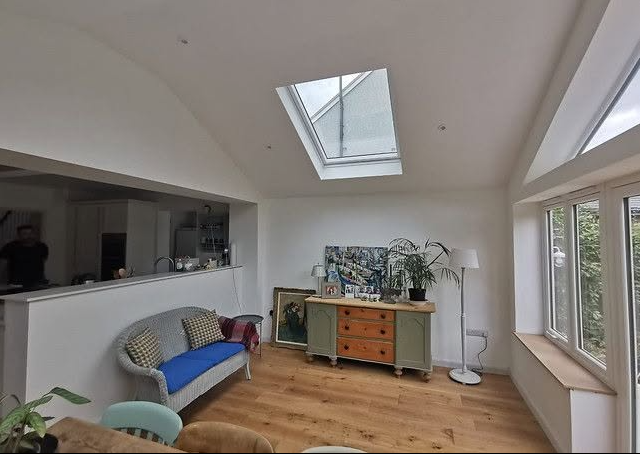 Bright extension interior with a large rooflight and white plastered walls